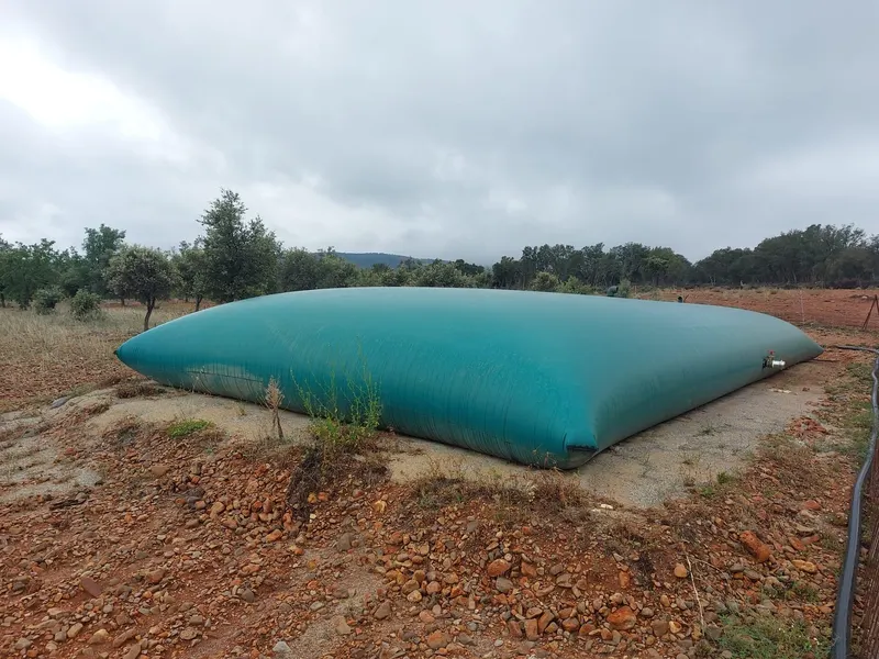 Depósito flexible para agua de riego instalado en una finca de olivos y almendros